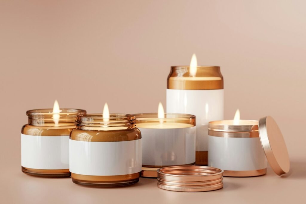 Lit scented candles in white and copper glass jars