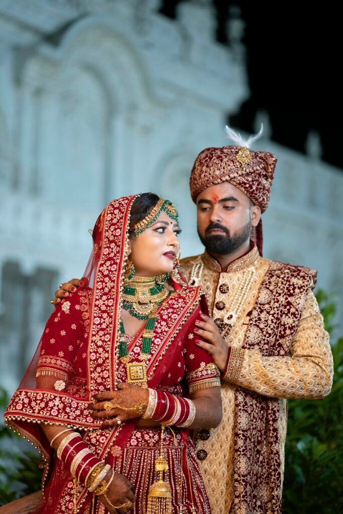 Couple in traditional Indian outfits, red and gold