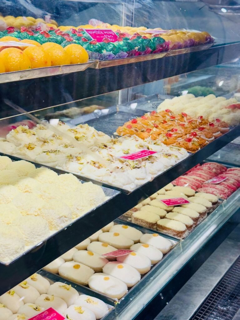 Indian sweets shop counter full of colourful mithai