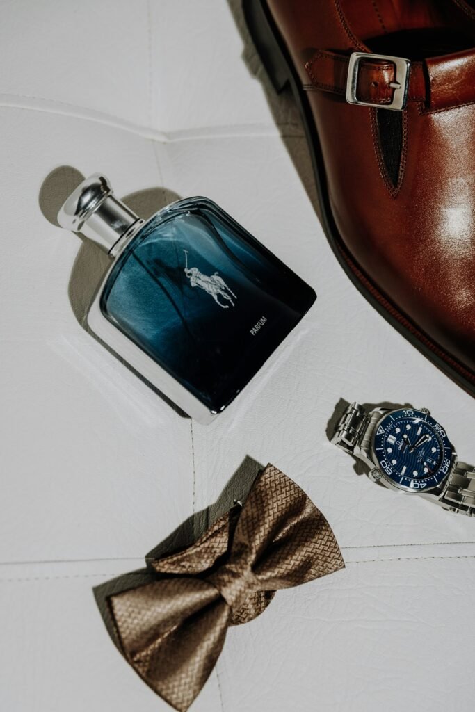 10 Luxury Diwali Gifts for Him and Her (₹5,000–₹30,000) in 2026 Cologne bottle, steel watch and bow tie laid out as a gift for him