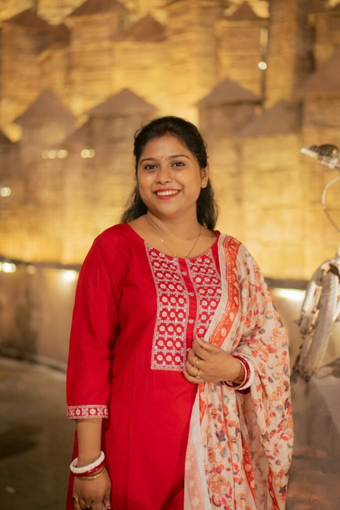 Smiling woman in a red kurta with a printed dupatta